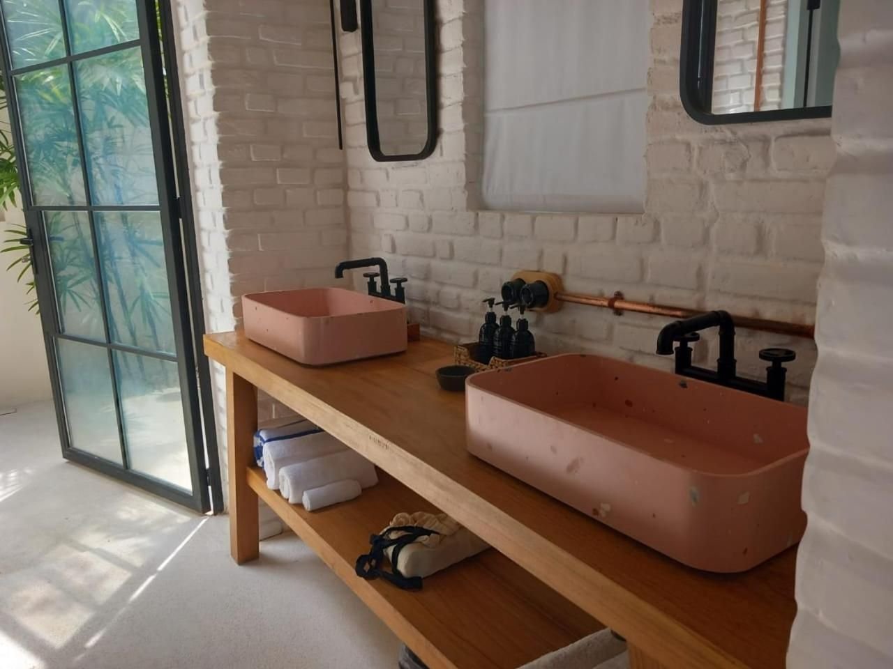 Pink terrazzo basin on a teak vanity