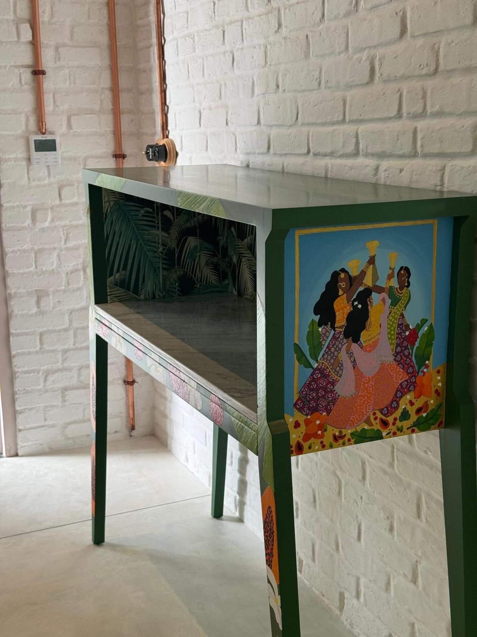 A hand-painted console against white brick