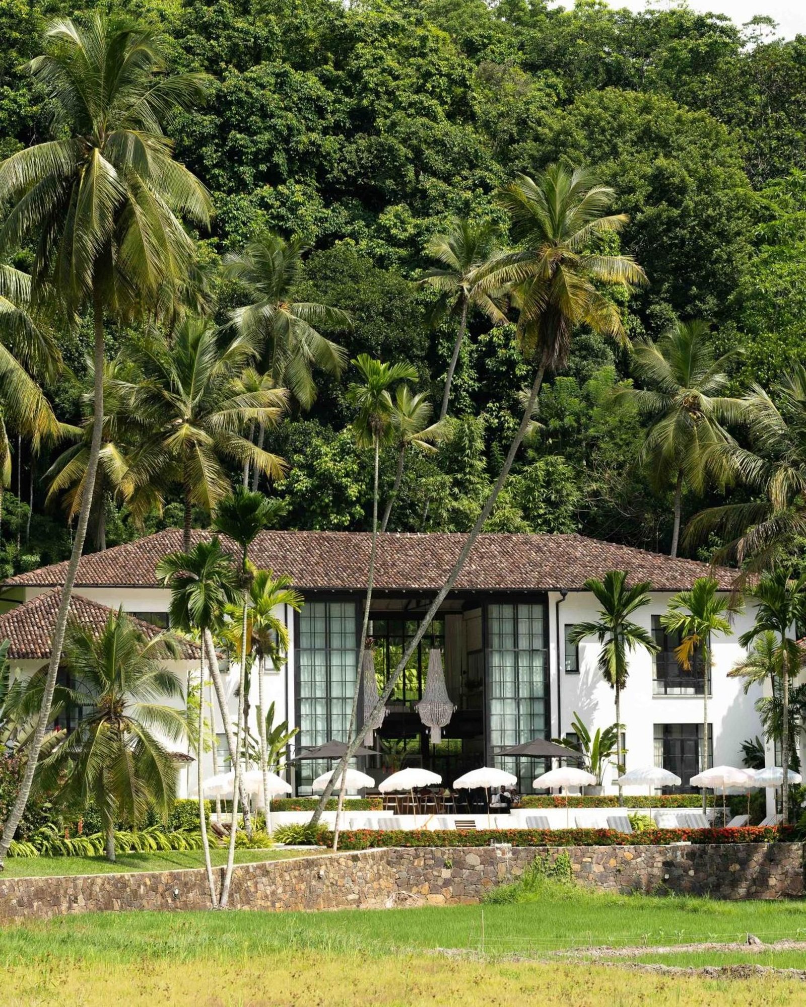 The facade seen across the paddy field