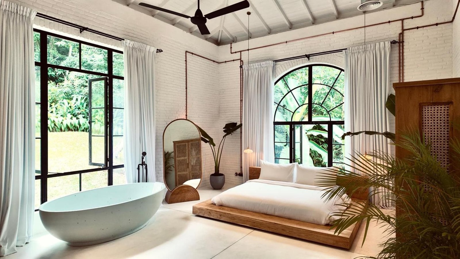 The King Loft, with a terrazzo tub beside the bed and arched steel windows