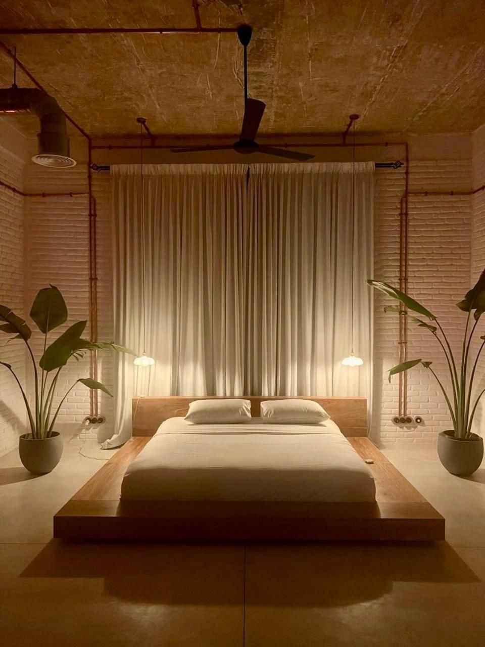 A loft bedroom in warm evening light
