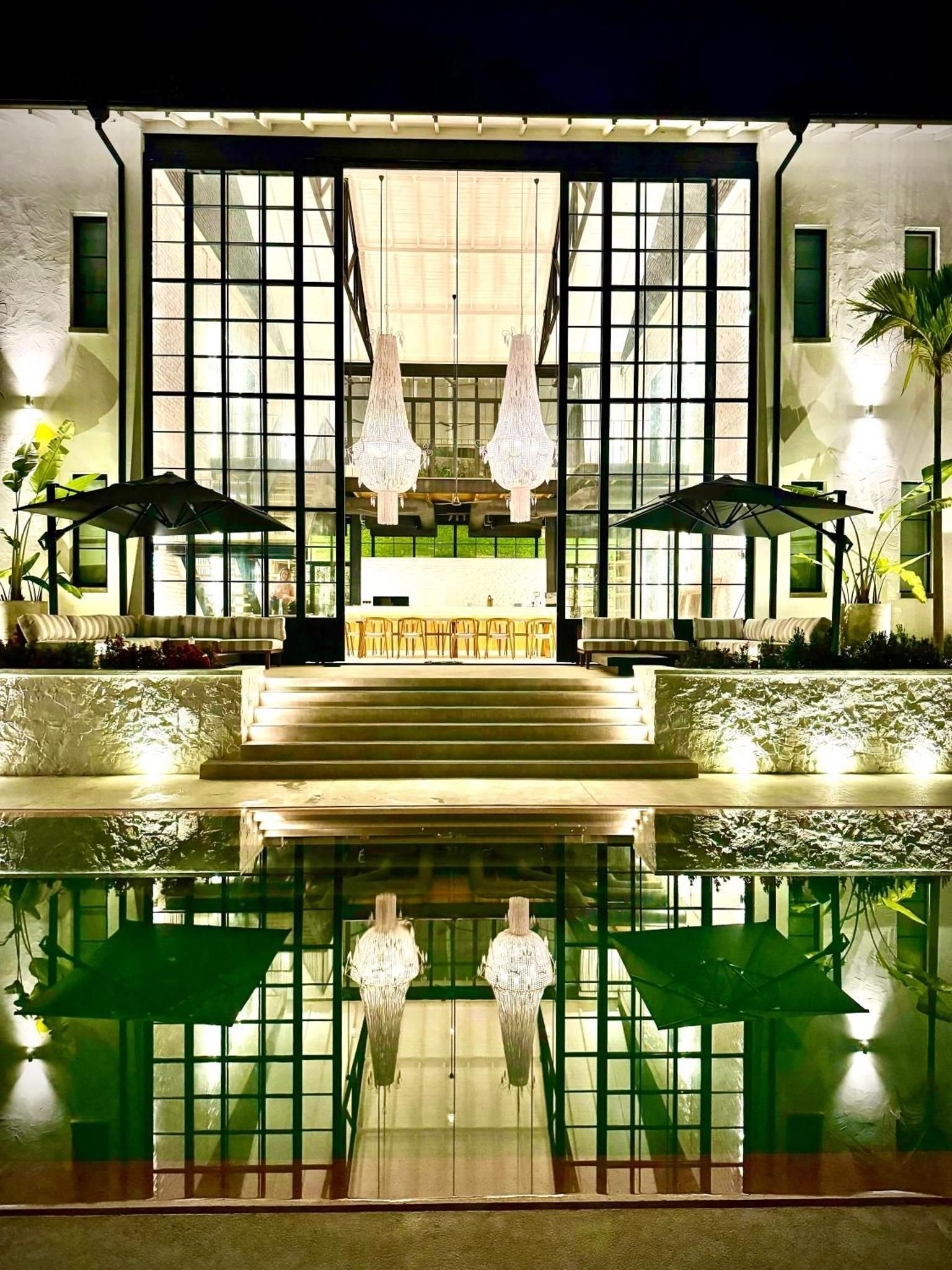 The dining hall reflected in the pool at night