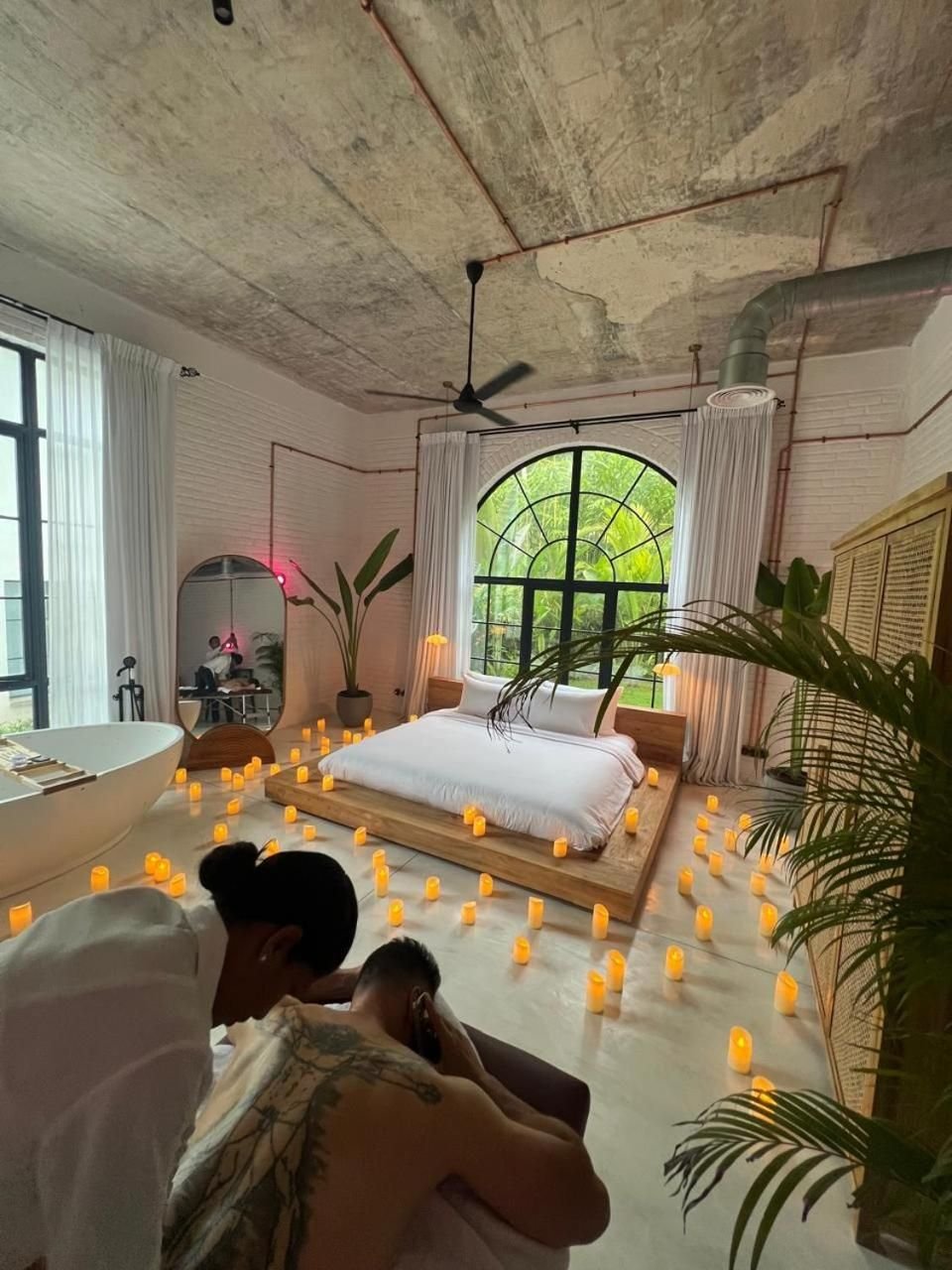 A couple relaxing in a candlelit loft