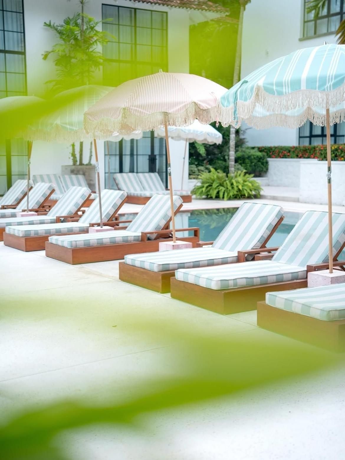Striped sun loungers and umbrellas beside the pool